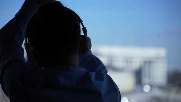 Silhouette of Woman Relaxing During Dance in Hotel