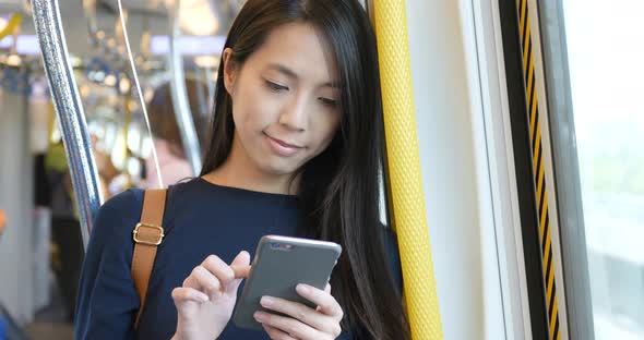 Woman use of mobile phone on train