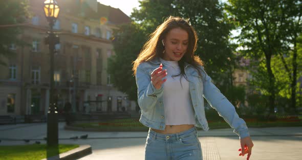 A Cheerful Girl Is Singing and Dancing