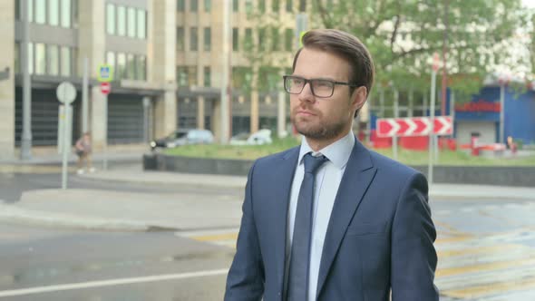 Side Pose of Businessman Walking in a Street in Slow Motion