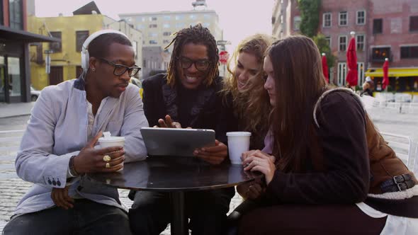 Group of friends looking at digital tablet together