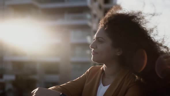 Portrait of Successful Businesswoman in City Looking at Sunset