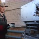A Professional Caucasian Engineer in Overalls Processes a Sheet of Metal on a Machine - VideoHive Item for Sale