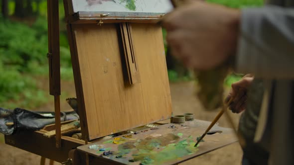 Hands of a Young Girl Artist Hold a Brush.