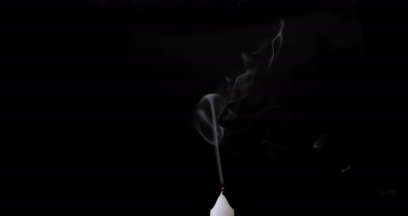 Smoke effect isolated on black background. White smoke slowly floating up from the white candle