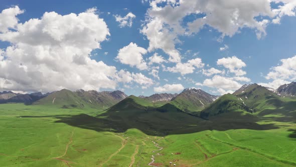 Vast grasslands and mountains in a fine day