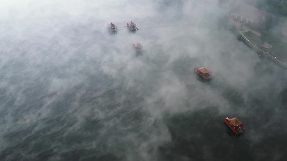 Aerial View of Sunrise with Fog Over Ban Rak Thai Chinese Village Near a Lake in Mae Hong Son