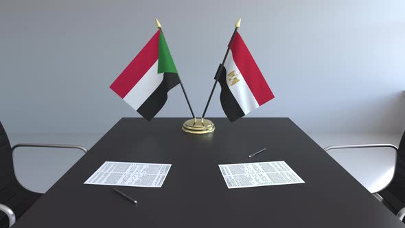 Flags of Sudan and Egypt on the Table