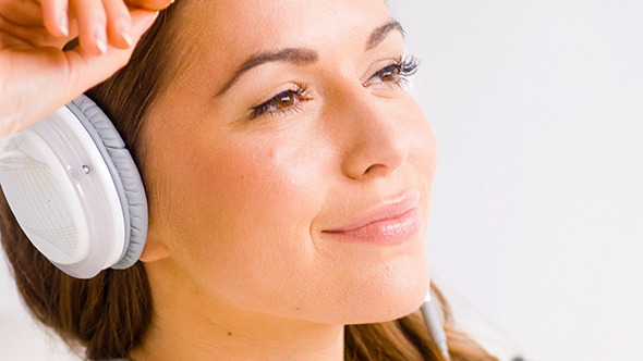 Happy Girl Listening to Music in White Headphones