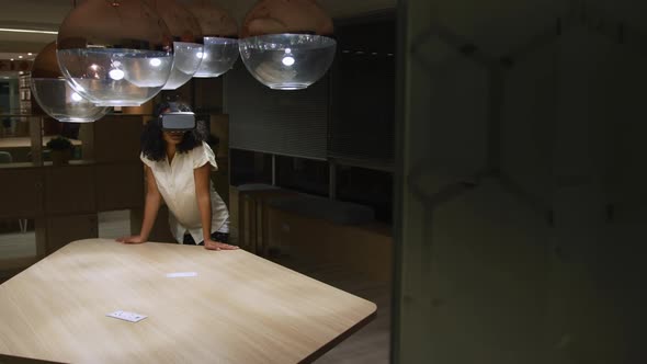 Businesswoman using VR helmet in a modern office