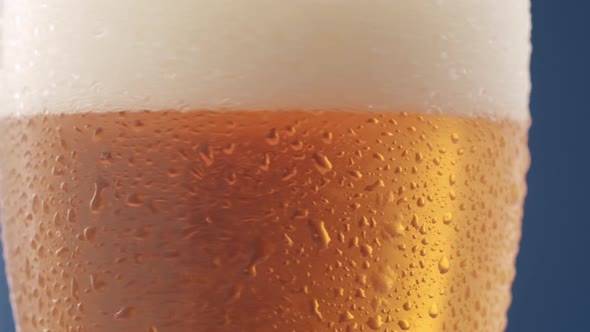 Glass of Beer Turns Slowly Around Its Axis