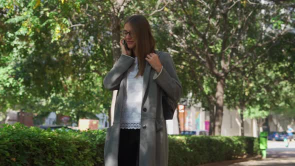 Woman talking on smartphone on park