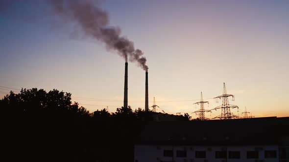 Industrial pipes of the thermal power plant at sunset.