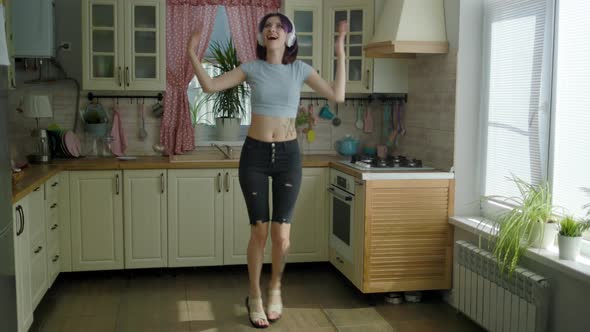 Young Beautiful Woman Dancing Kitchen At Home In Headphones