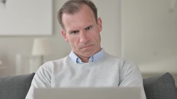 Portrait of Middle Aged Businessman Thinking and Working From Home 