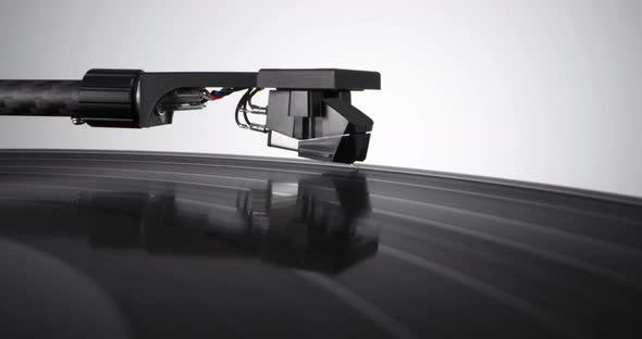 Tonearm Headshell Descends on Vinyl Record with Colorful Label