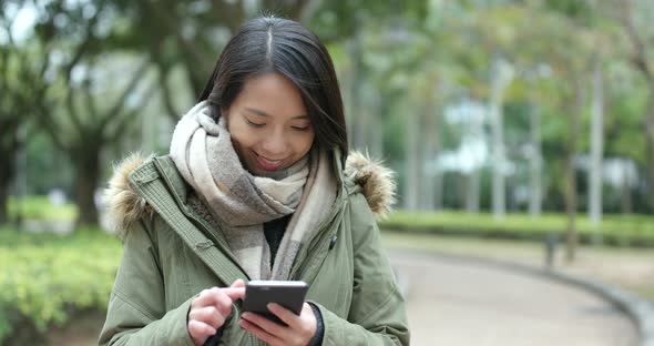 Woman use of mobile phone in park