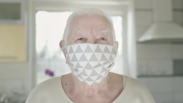 Portrait Of Old Woman In Medical Mask. Woman Protects Herself From Infections In Pandemic