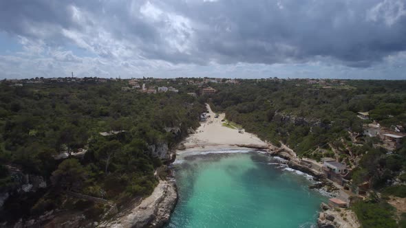 Ascending towards the clouds above the clear waters of a beautiful secluded cove