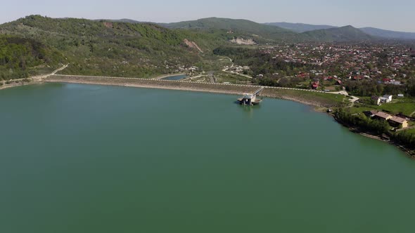 Aerial View Of Calm Waters Of Maneciu Dam In Prahova County, Romania. dolly-in drone, tilt down