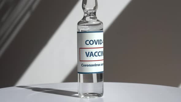Coronavirus Covid Vaccines Rotate on a White Background in a Medical Laboratory