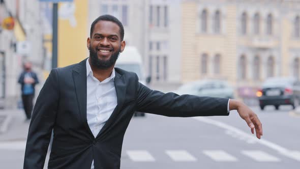 Confident Calm African American Young Guy in Suit Waiting for Cab on Sidewalk Outdoors