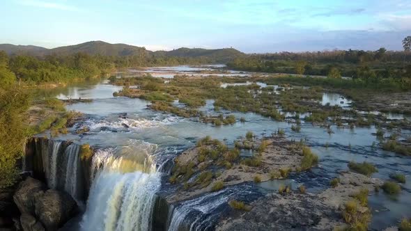 Low Flight Over Wide River Against Distant Hills