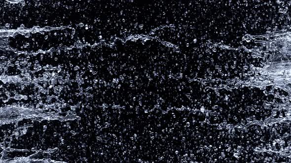 Super Slow Motion Shot of Water Side Splashes Isolated on Black Background at 1000Fps alt