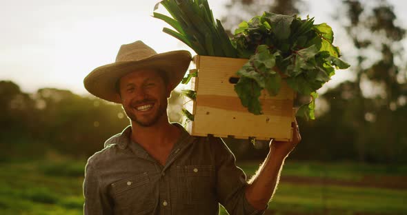 Portrait of farmer holding his harvest alt