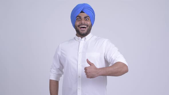Happy Young Bearded Indian Sikh Man Giving Thumbs Up