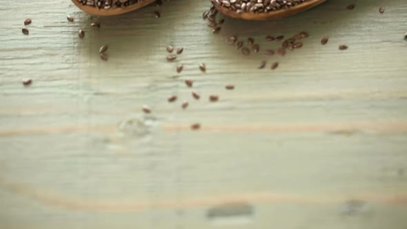 Flax seeds on painted wood board.