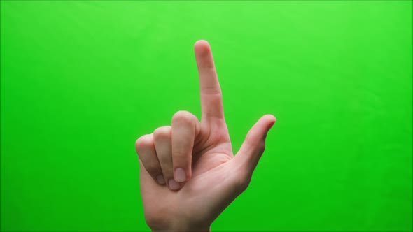 Closeup of a Hand Gesture on a Green Background Index Finger Up Gesture Forefinger Shooting a