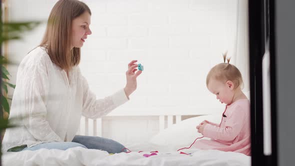 Little Baby Girl and Mommy Playing Color Wooden Toys at Home Mother and Daughter Laughing Having Fun