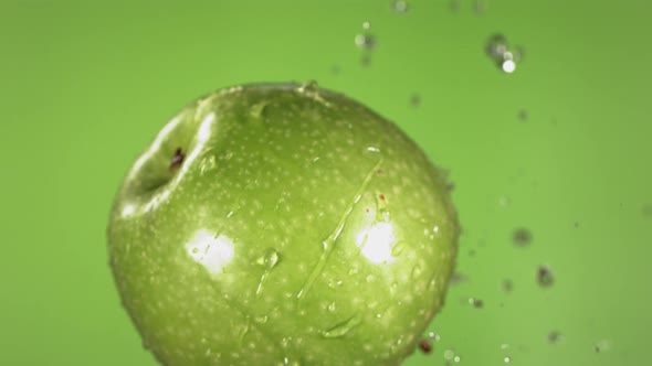 Flying of Green Apple in Green Background in Slow Motion