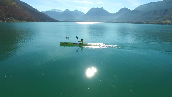 A kayaker paddles in a scenic mountain lake.