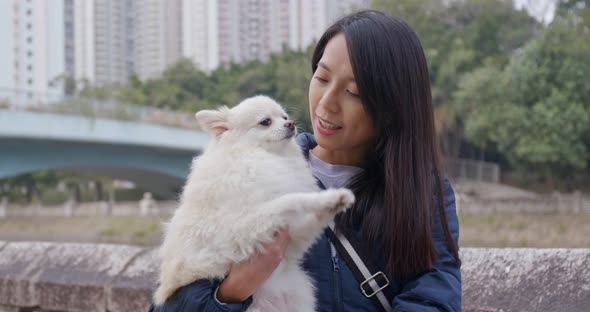 Woman go out with her pomeranian dog