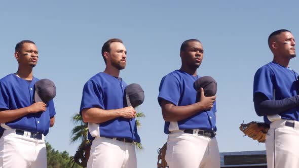 Baseball players standing on line