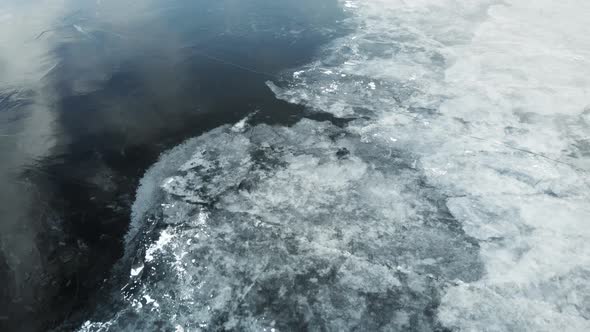 Aerial View of a Frozen River. Fancy Ice Texture, Cold Chained Water. Shards of Ice Stick Out with