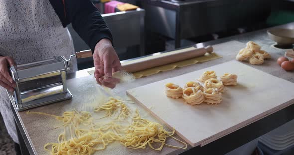 Woman working inside pasta factory - Traditional italian pasta