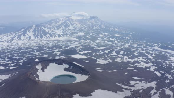 Gorely Volcano Crater Lake with Mutnovsky Volcano on the Background