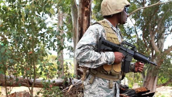 Military soldier guarding with a rifle