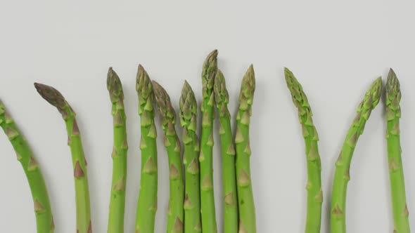 Video of fresh asparagus over white background
