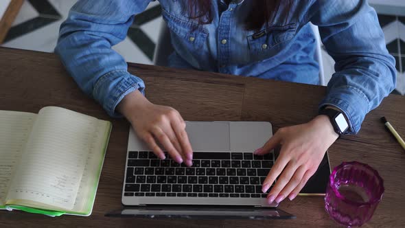 Woman is Typing on Laptop Keyboard at Home is Engaged in Selfeducation Online