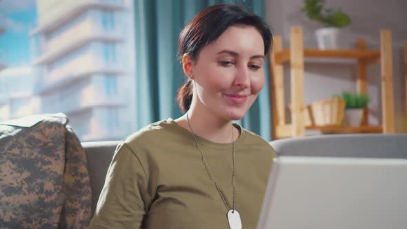 Portrait Young Smiling Military Woman Sits at Her Laptop