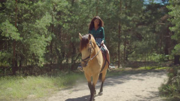 Female Rider Enjoying Horseback Riding in Nature