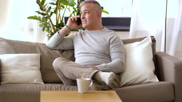 Happy Man Calling on Smartphone at Home 34