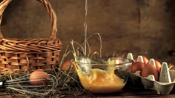 Super Slow Motion Raw Egg Falls Into the Bowl with Splashes