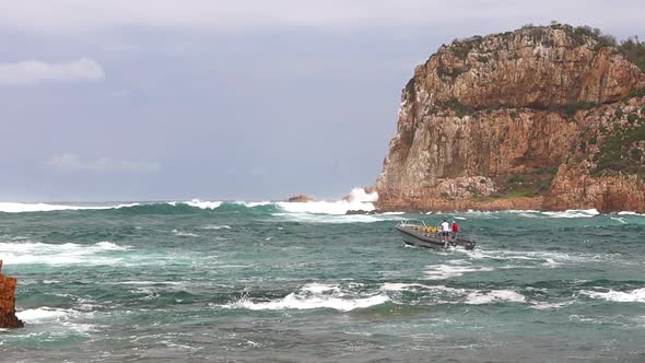 A commercial passenger vessel slowly investigates the Knysna Heads before turning back because of th