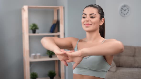 Happy Young Female Warming Up Stretching Hands Practicing Domestic Morning Physical Activity