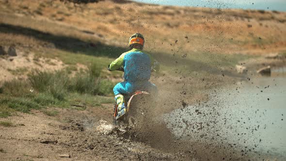 Motorcycle splashing mud behind